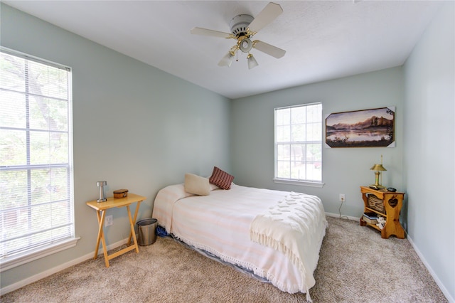 bedroom with ceiling fan and light colored carpet