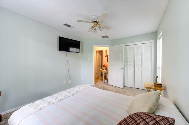 bedroom featuring light carpet, ceiling fan, and a closet