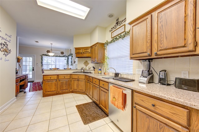 kitchen with backsplash, light tile patterned flooring, sink, and stainless steel appliances