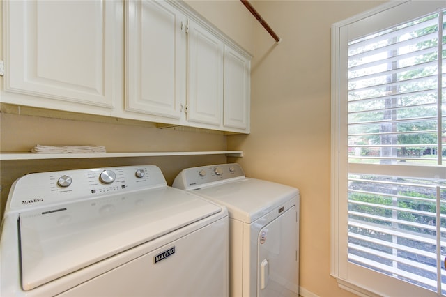 laundry room with washer and clothes dryer and cabinets