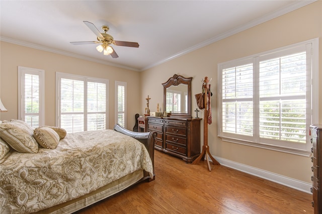 bedroom with ceiling fan, ornamental molding, light hardwood / wood-style floors, and multiple windows