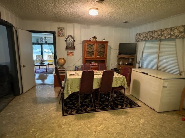 dining area featuring a textured ceiling