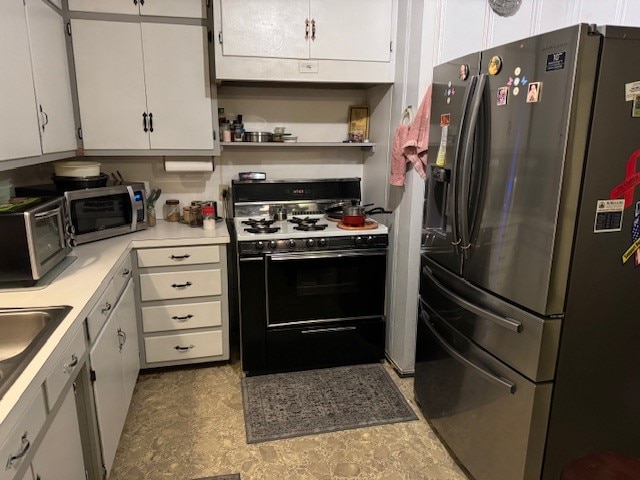 kitchen featuring white cabinets and appliances with stainless steel finishes