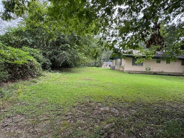 view of yard featuring central air condition unit