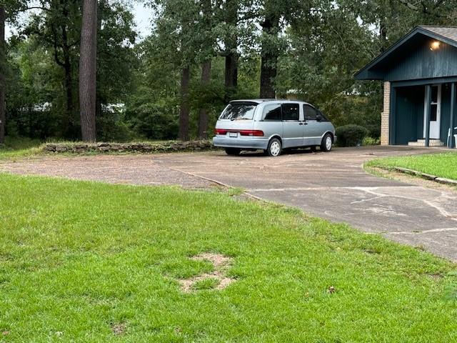 view of car parking featuring a yard