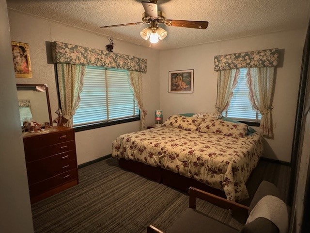 bedroom with ceiling fan and a textured ceiling