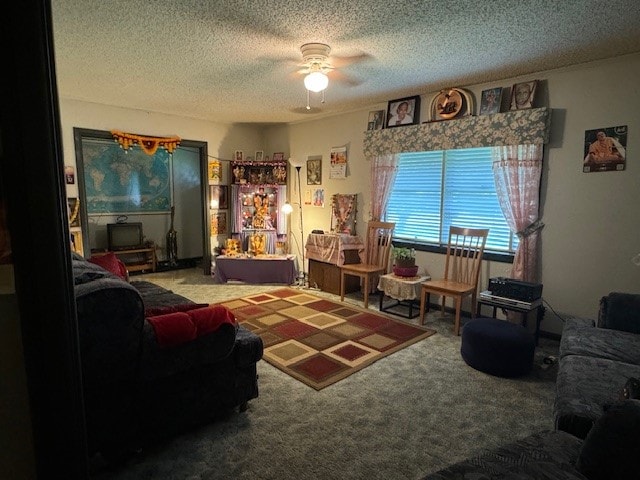 living room featuring carpet floors, a textured ceiling, and ceiling fan