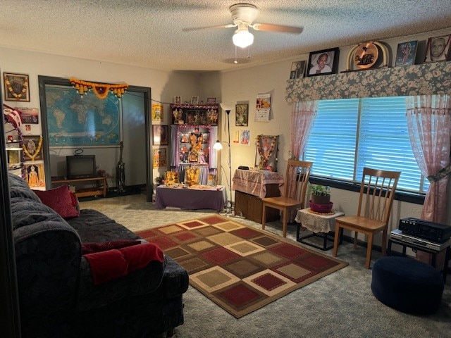 living room featuring carpet floors, a textured ceiling, and ceiling fan