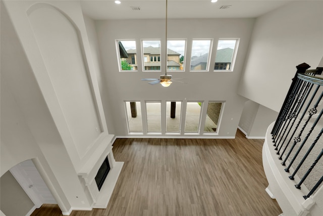 unfurnished living room featuring light hardwood / wood-style flooring and ceiling fan