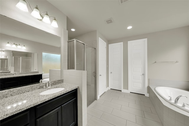 bathroom featuring tile patterned floors, separate shower and tub, and vanity