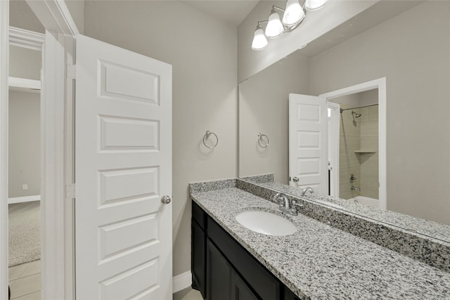 bathroom featuring tile patterned floors, tiled shower / bath combo, and vanity