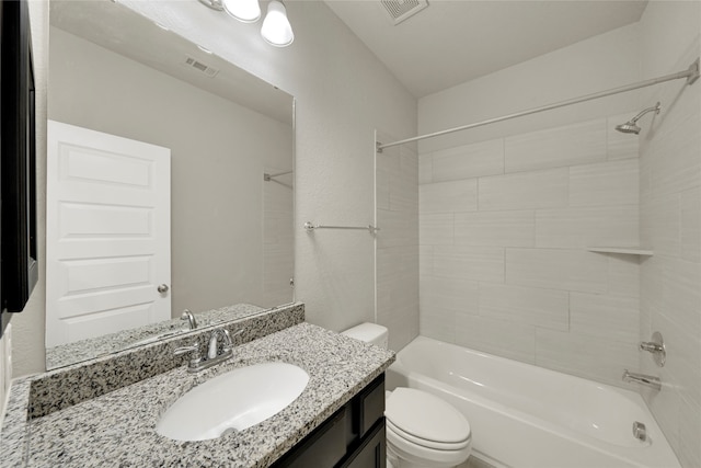 full bathroom featuring vanity, toilet, and tiled shower / bath combo