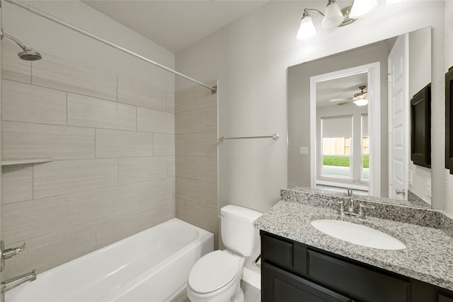 full bathroom with vanity, toilet, tiled shower / bath combo, and ceiling fan