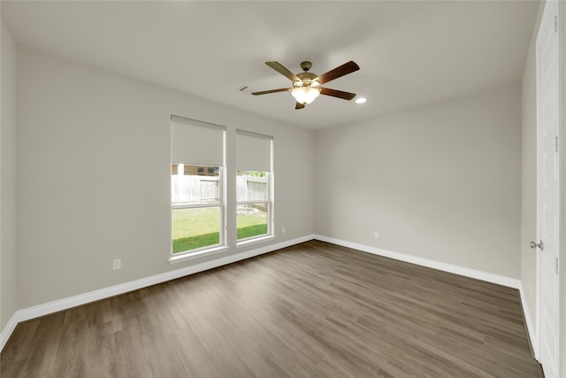 unfurnished room with ceiling fan and dark hardwood / wood-style flooring