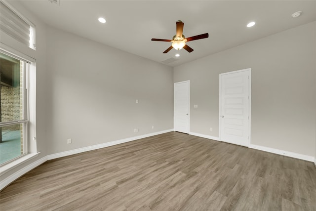 unfurnished room with light wood-type flooring and ceiling fan