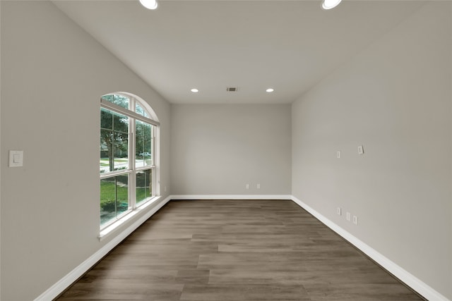 unfurnished room featuring dark wood-type flooring