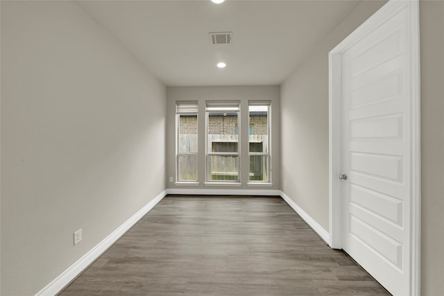 spare room featuring dark wood-type flooring