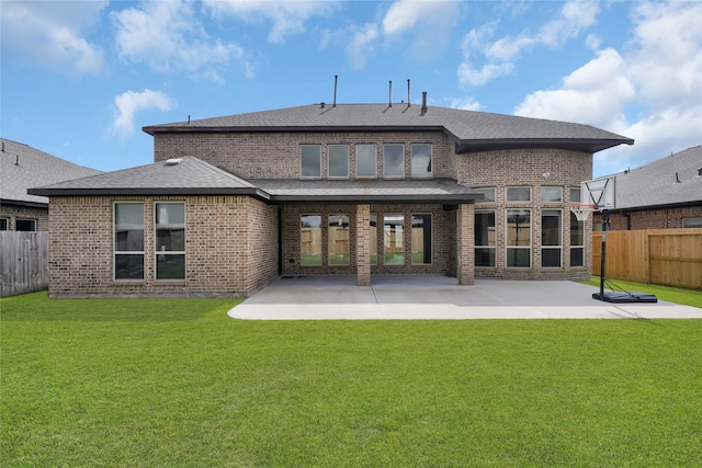 rear view of property with a yard and a patio