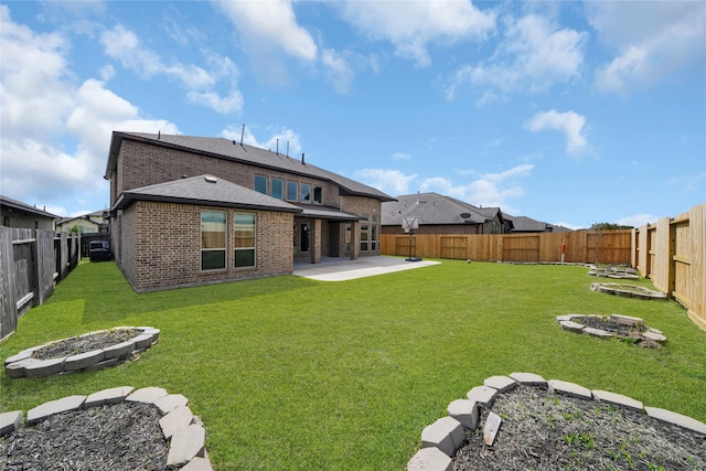 rear view of house featuring a lawn and a patio area