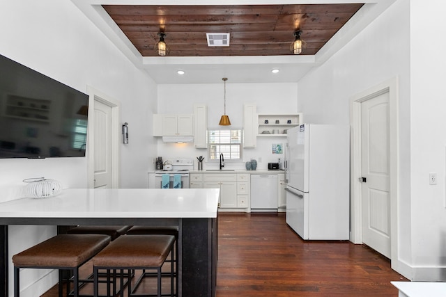 kitchen with sink, wood ceiling, white appliances, and hanging light fixtures