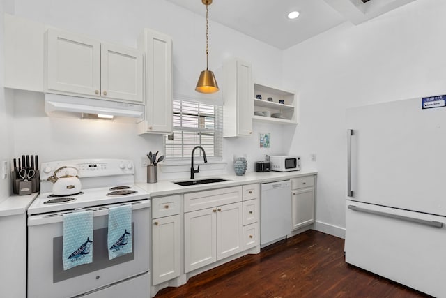 kitchen featuring sink, decorative light fixtures, dark hardwood / wood-style floors, white appliances, and white cabinets