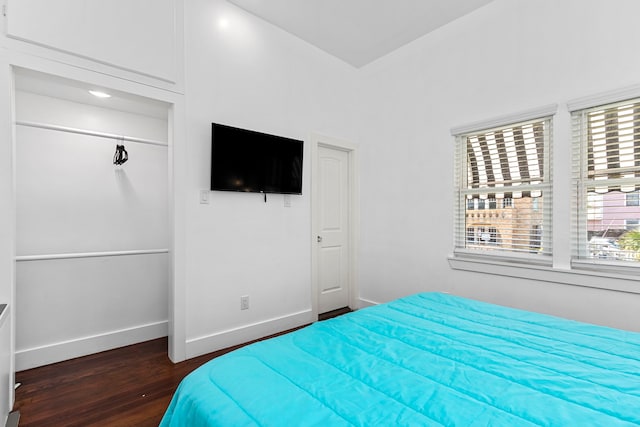 bedroom featuring dark hardwood / wood-style floors and a closet