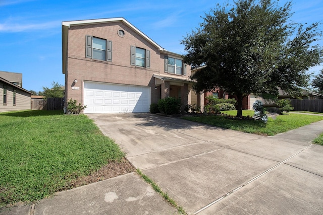 view of front of property with a front yard and a garage