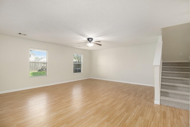 spare room with ceiling fan and light hardwood / wood-style floors