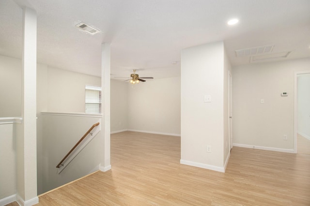 empty room featuring ceiling fan and light wood-type flooring