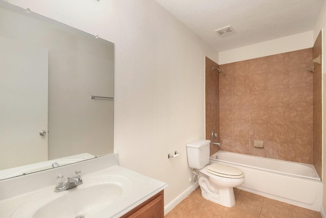 full bathroom featuring tile patterned flooring, a textured ceiling, toilet, vanity, and tiled shower / bath