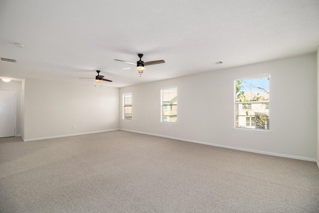 empty room with ceiling fan and light carpet