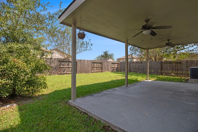 view of yard with ceiling fan and a patio