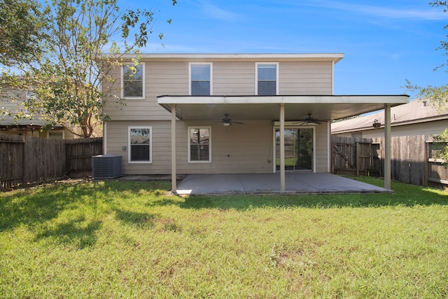 back of property with a patio area, ceiling fan, cooling unit, and a lawn