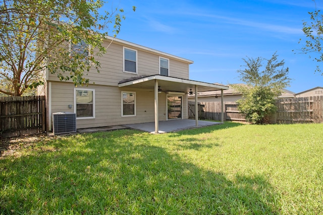 rear view of house featuring ceiling fan, a patio area, central air condition unit, and a yard