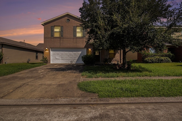 view of front facade with a garage and a lawn