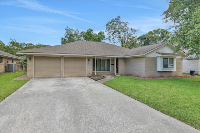 ranch-style home featuring a garage, central AC unit, and a front lawn