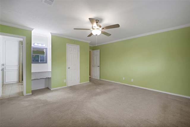 unfurnished bedroom with ceiling fan, connected bathroom, crown molding, and light carpet