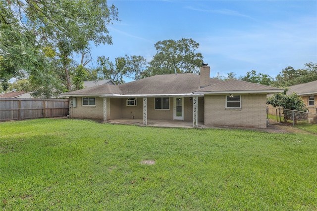 rear view of house with a yard and a patio area