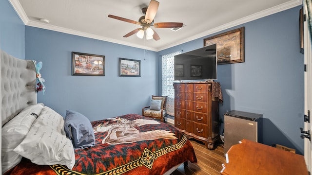 bedroom with ceiling fan, ornamental molding, and wood-type flooring