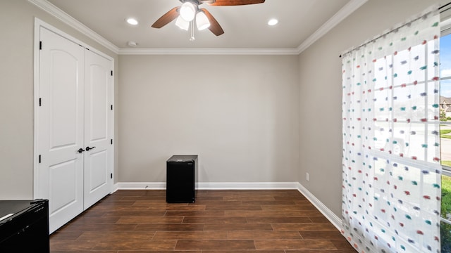 unfurnished bedroom with dark wood-type flooring, multiple windows, ceiling fan, and a closet