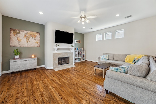 living room with ceiling fan and dark hardwood / wood-style flooring