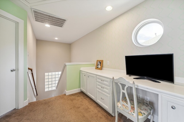 home office featuring light carpet and built in desk