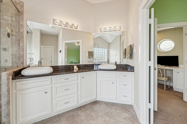 bathroom featuring vanity, lofted ceiling, and a shower with shower door