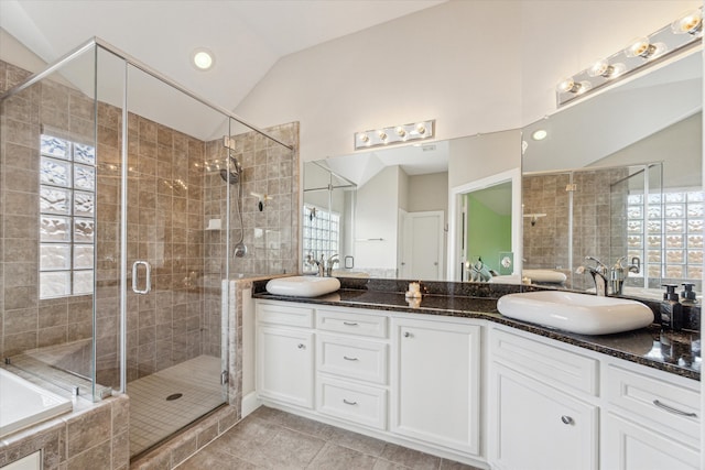 bathroom with lofted ceiling, vanity, plenty of natural light, and walk in shower