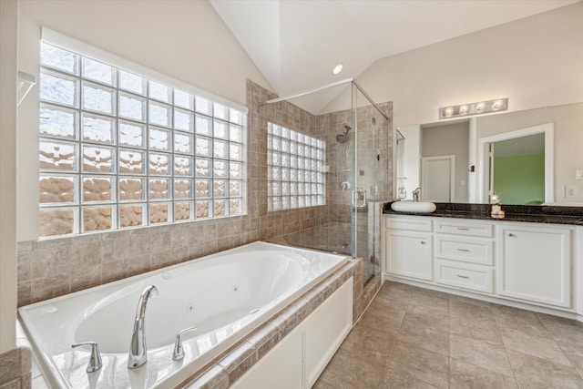 bathroom featuring vanity, plus walk in shower, tile patterned flooring, and vaulted ceiling