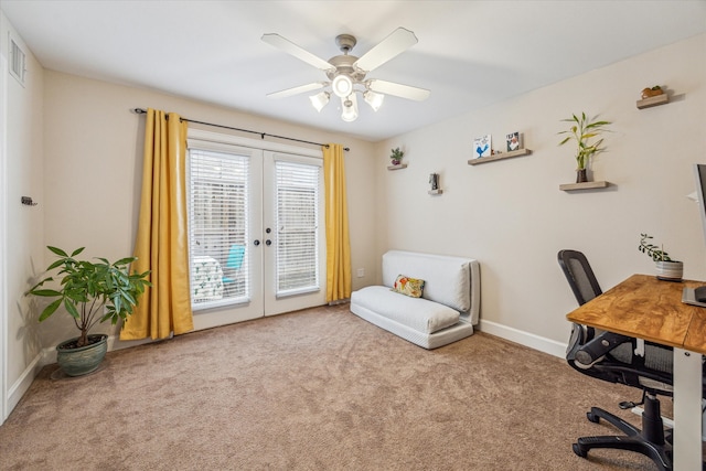 carpeted office space with french doors and ceiling fan