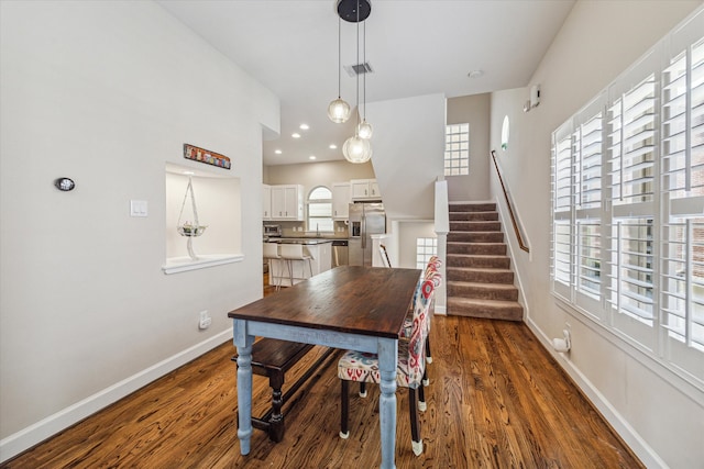 dining space with dark hardwood / wood-style floors