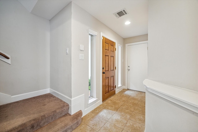 foyer entrance with light tile patterned floors