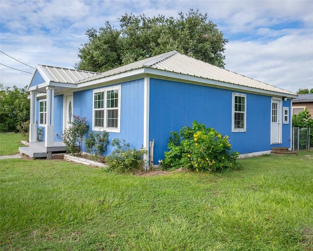 view of side of home featuring a yard