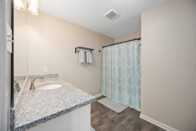 bathroom with hardwood / wood-style floors, vanity, and a shower with shower curtain